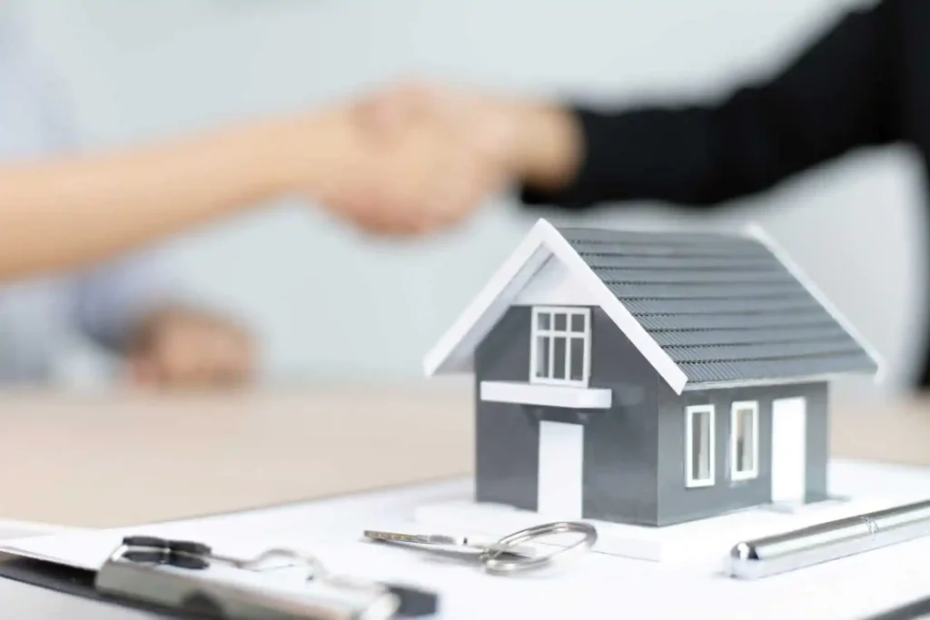 Maqueta de vivienda y acuerdo para comparar condiciones de una hipoteca fija